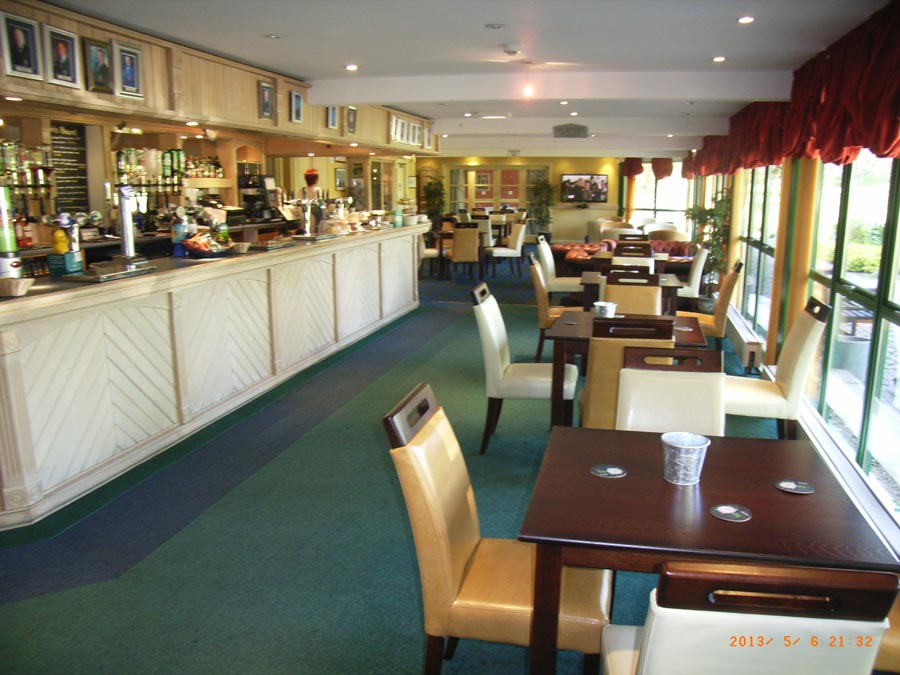Pleasant bar and dining area overlooking the putting green and 18th green