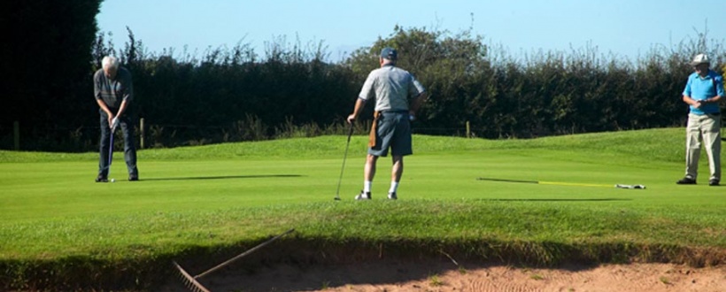 Putting out on the 6th green