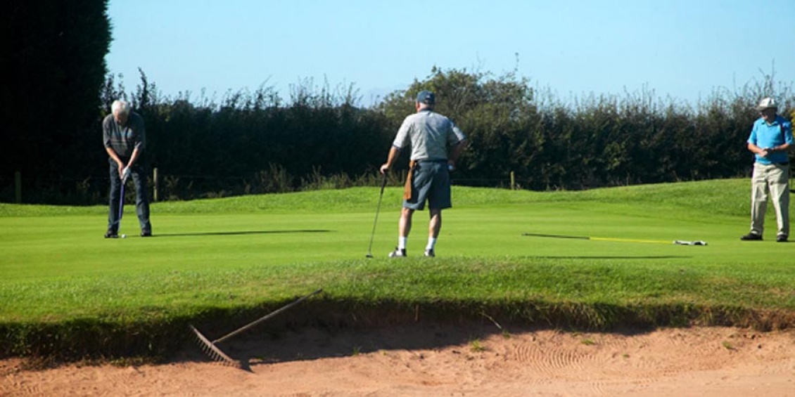 Putting out on the 6th green